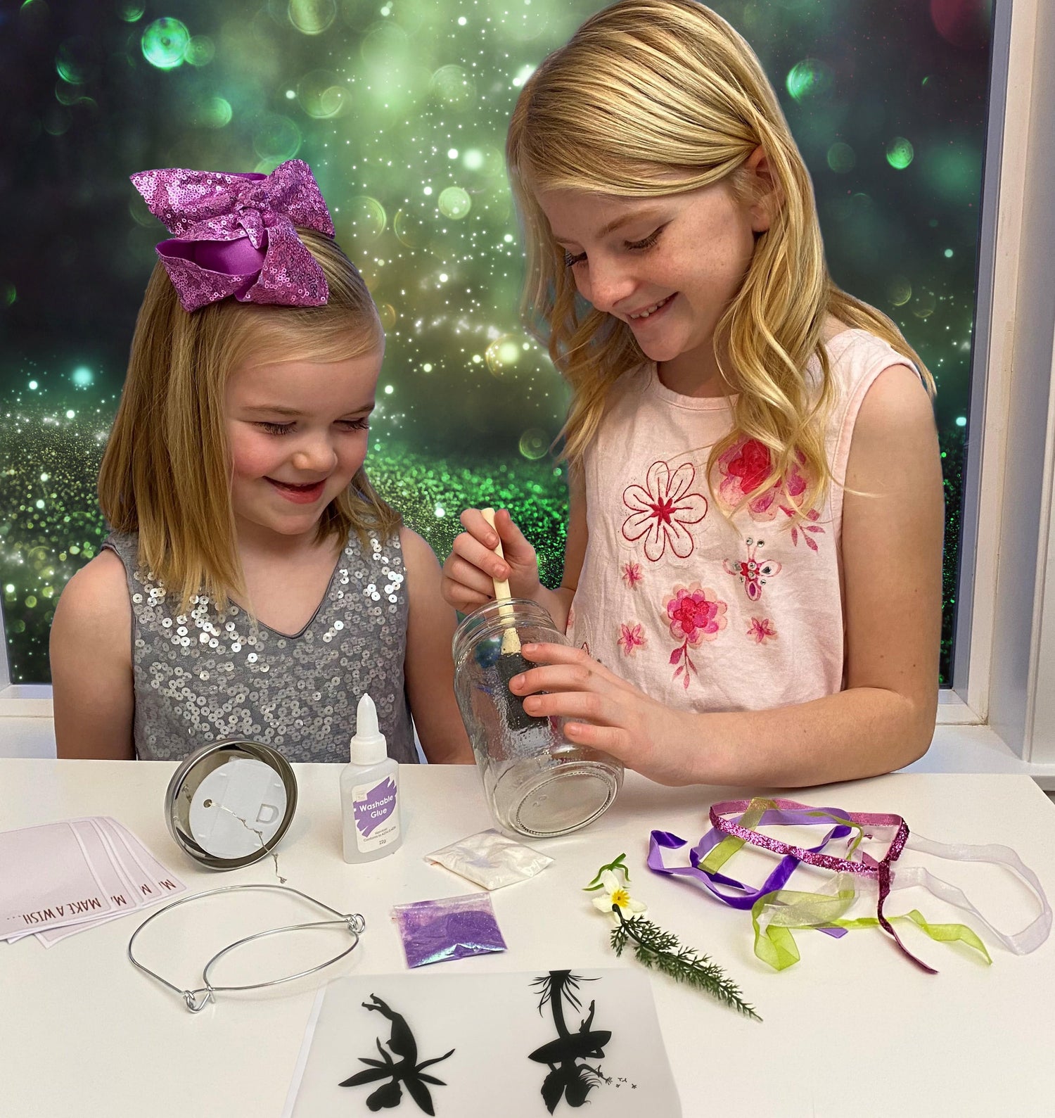 Two girls crafting DIY fairy lantern night lights together, using colorful materials and enjoying the creative process.